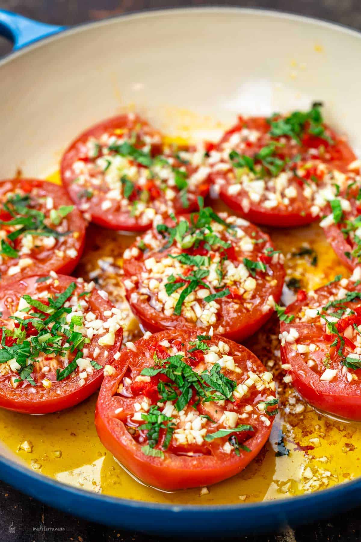 Fried tomatoes in frying pan