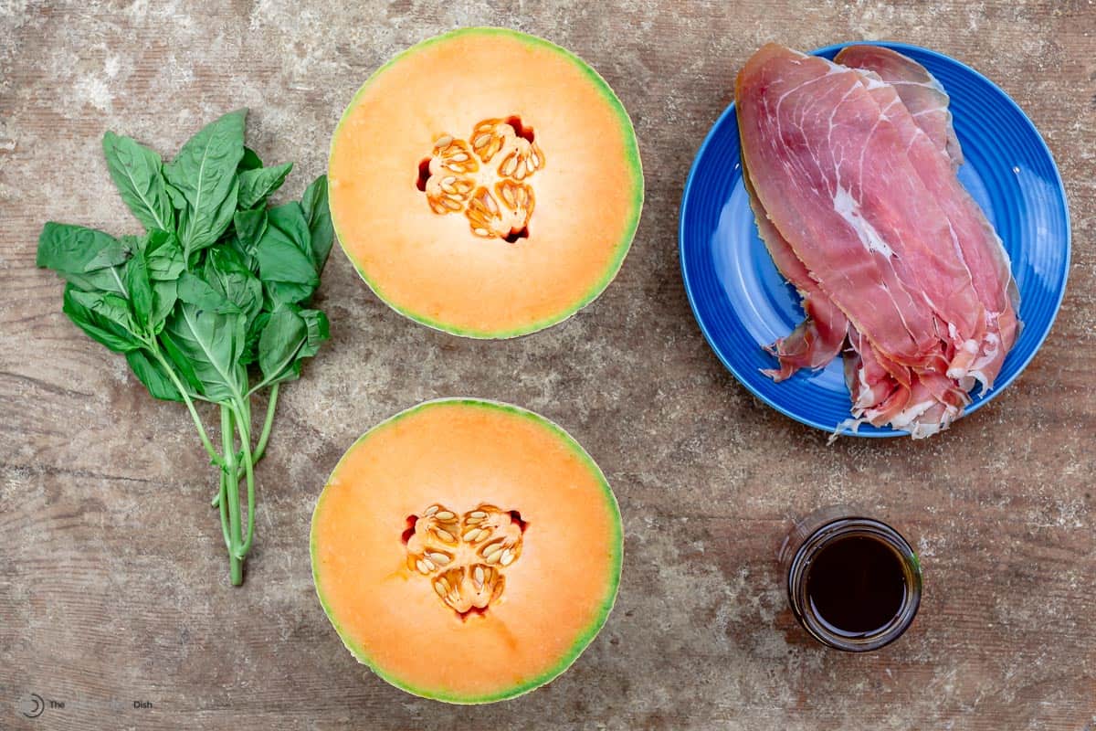 Ingredients including prosciutto, cantaloupe, honey, and basil