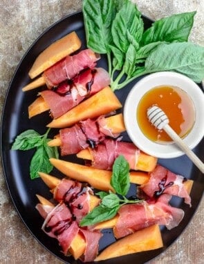 Prosciutto and melon served on a large plate