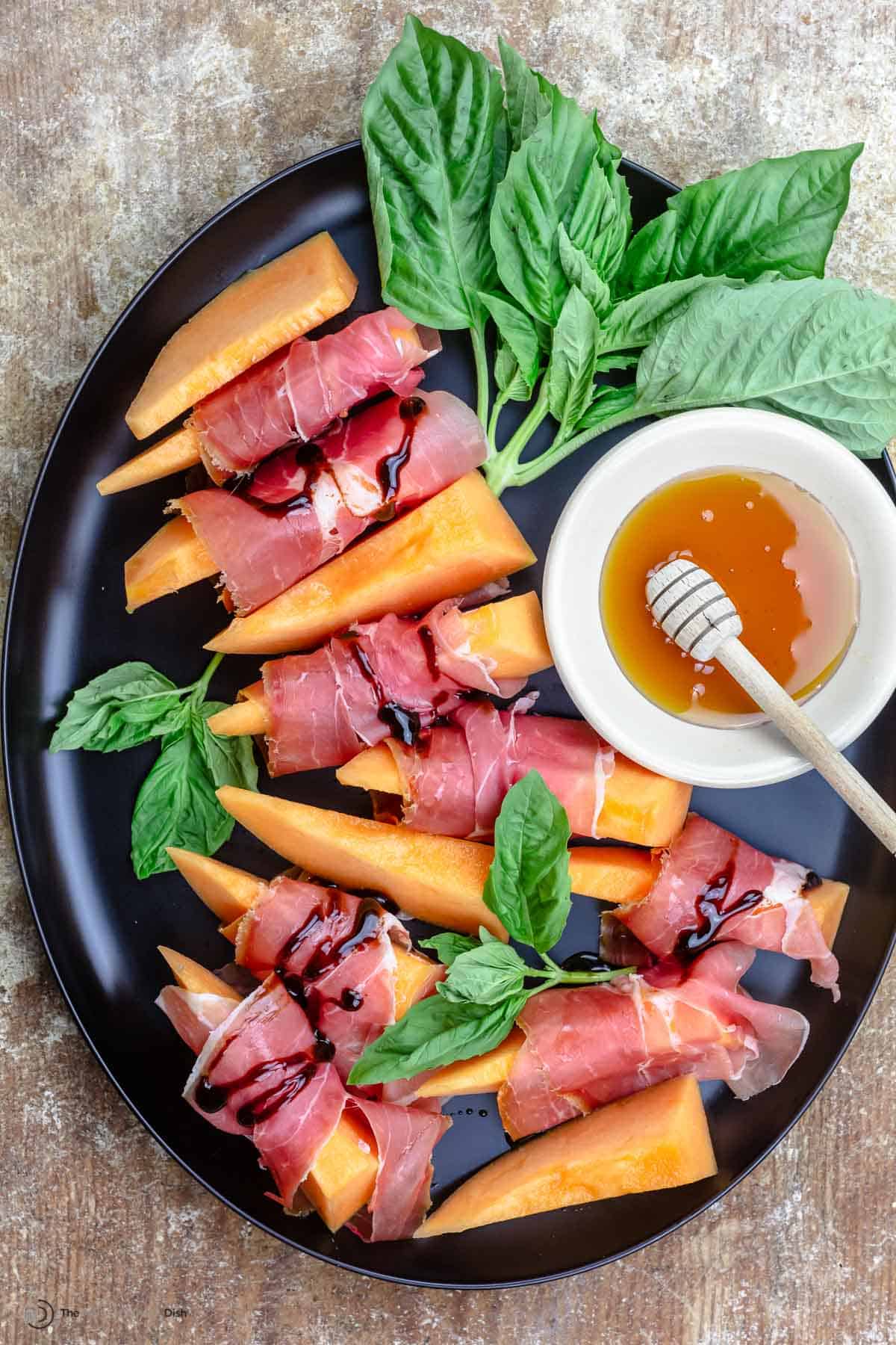 Prosciutto and melon served on a large plate