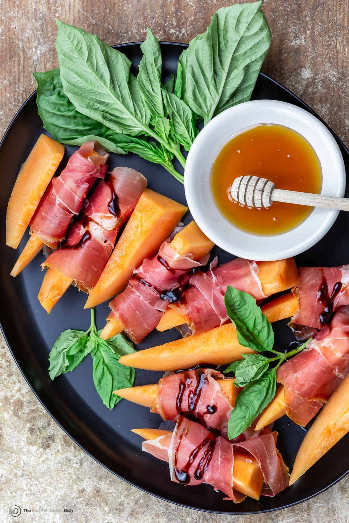 Prosciutto wrapped cantaloupe served on a plate