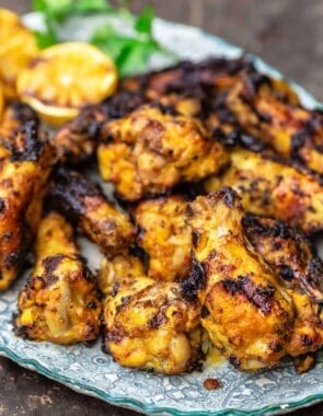 Grilled chicken wings piled on a plate