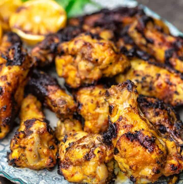 Grilled chicken wings piled on a plate