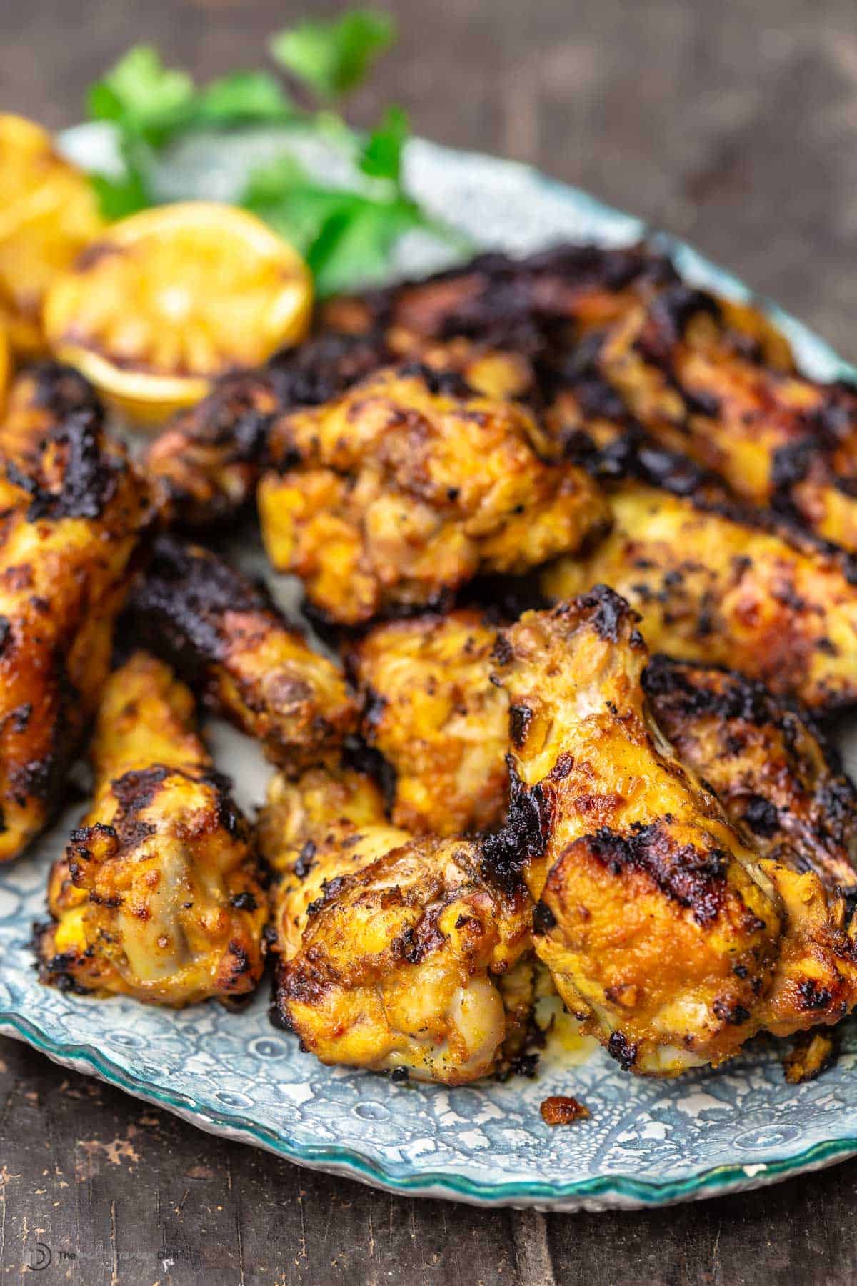 Grilled chicken wings piled on a plate