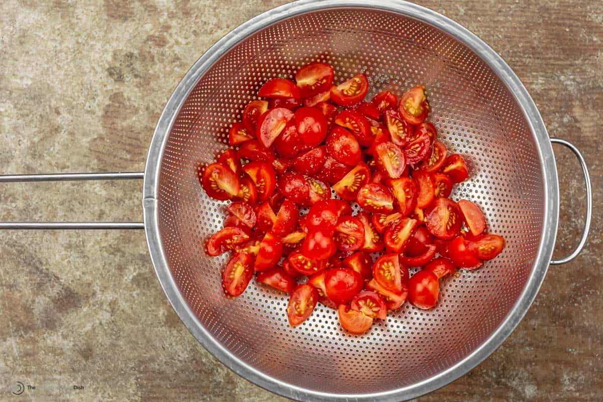 Cherry tomatoes cut up and place in colander