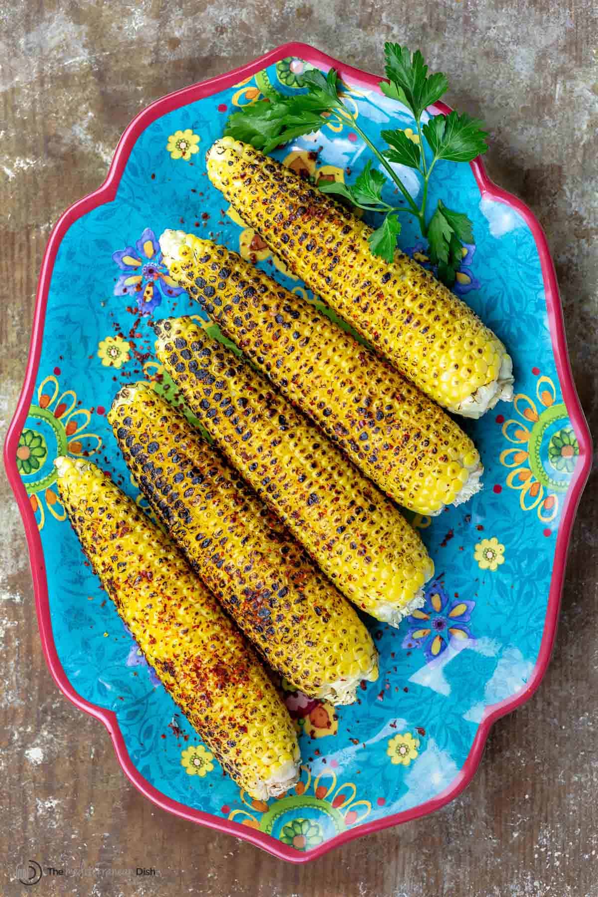Grilled corn on the cob topped with Aleppo pepper