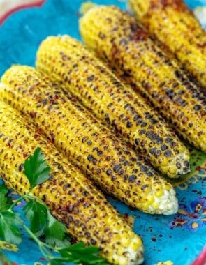 Slightly charred grilled corn on the cob topped with Aleppo pepper and lime
