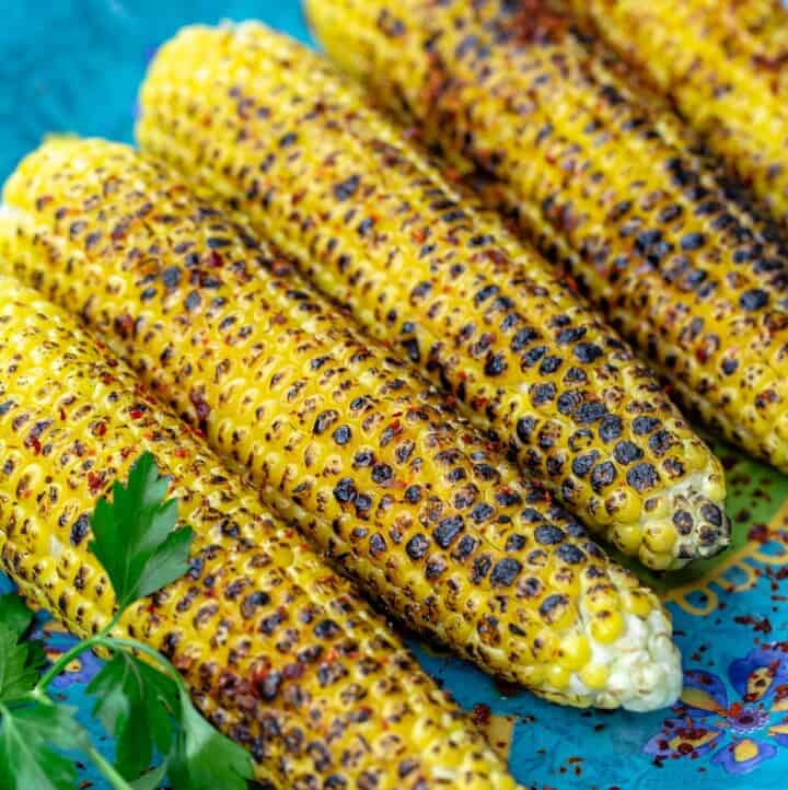 Slightly charred grilled corn on the cob topped with Aleppo pepper and lime