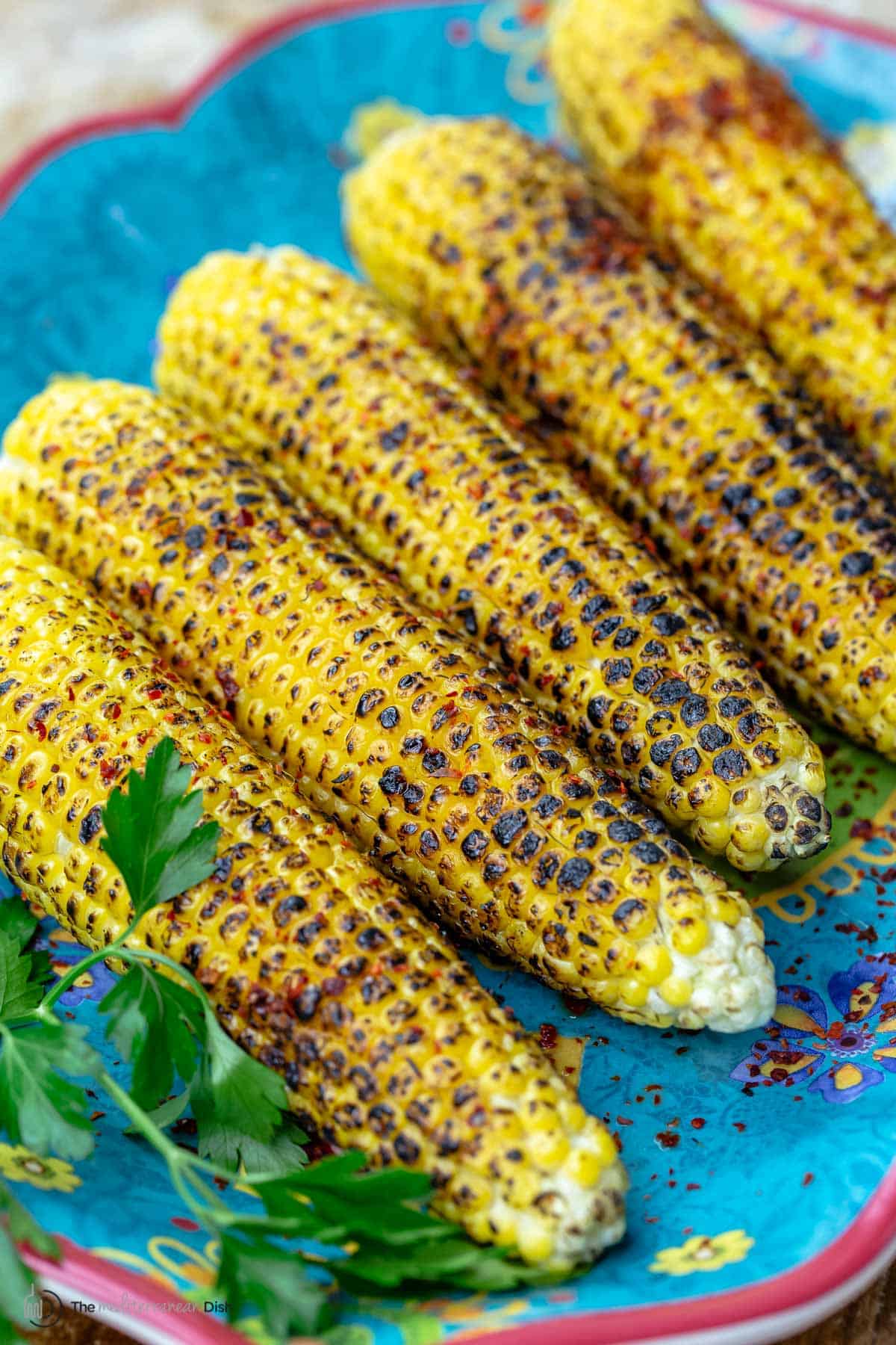 Slightly charred grilled corn on the cob topped with Aleppo pepper and lime