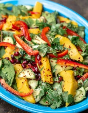 Savory mango salad on a blue plate