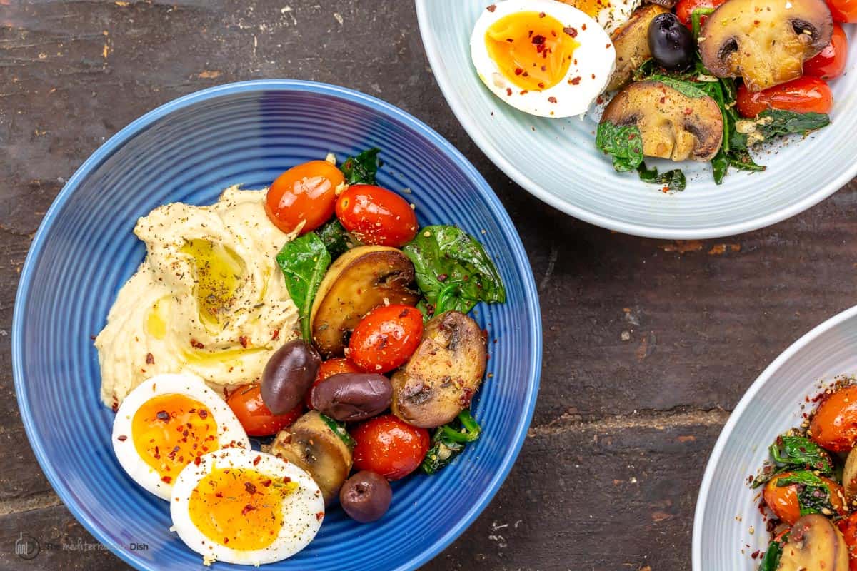 A healthy breakfast bowl (with eggs) on a plate blue
