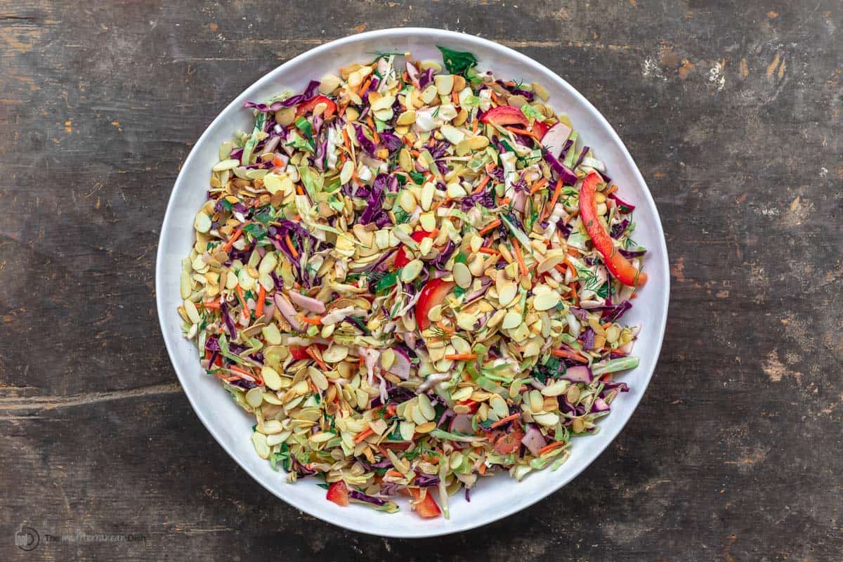 A large bowl of Mediterranean Cabbage Salad with Mustard Vinaigrette