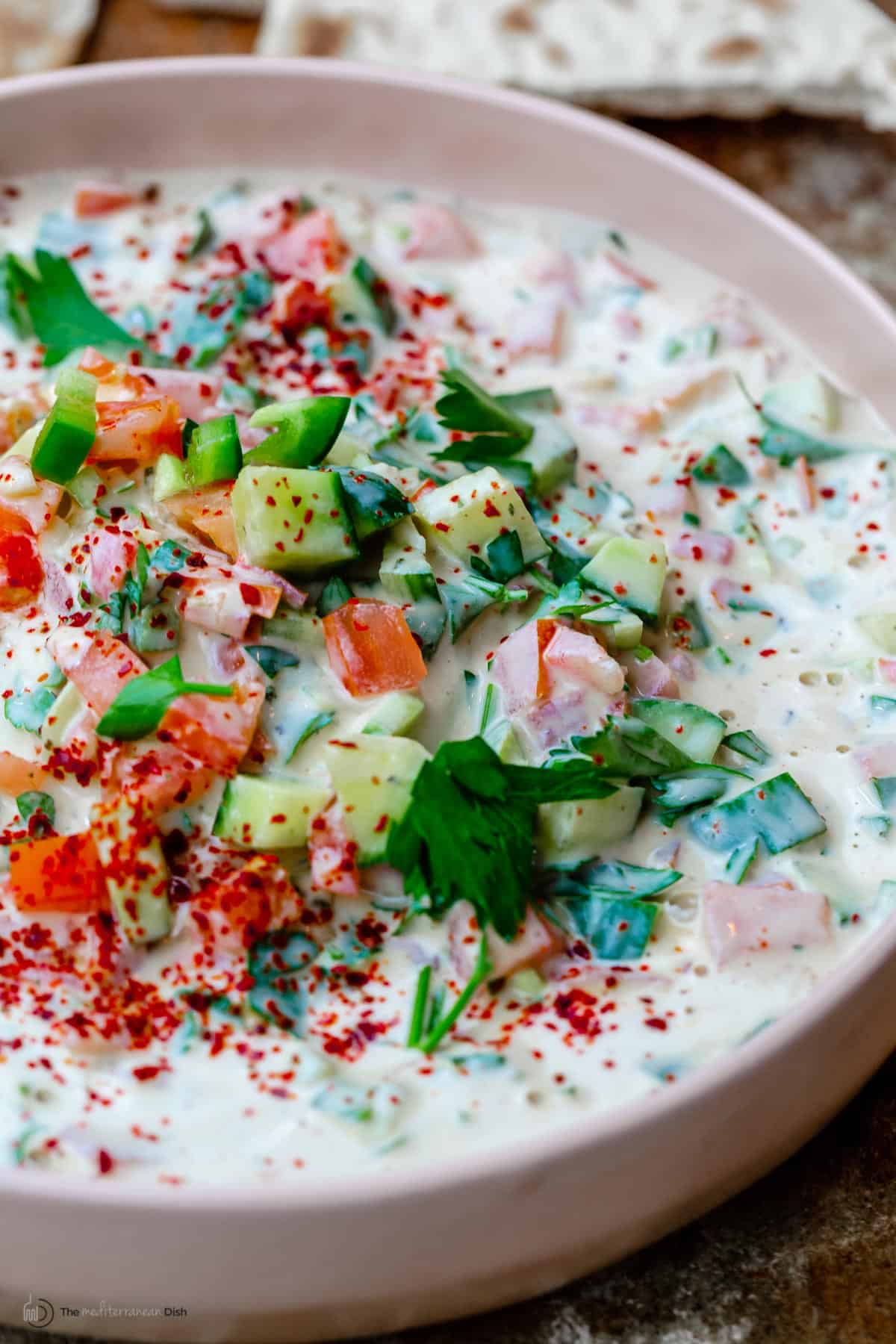 Tahini salad with cucumbers, tomatoes, parsley and aleppo pepper