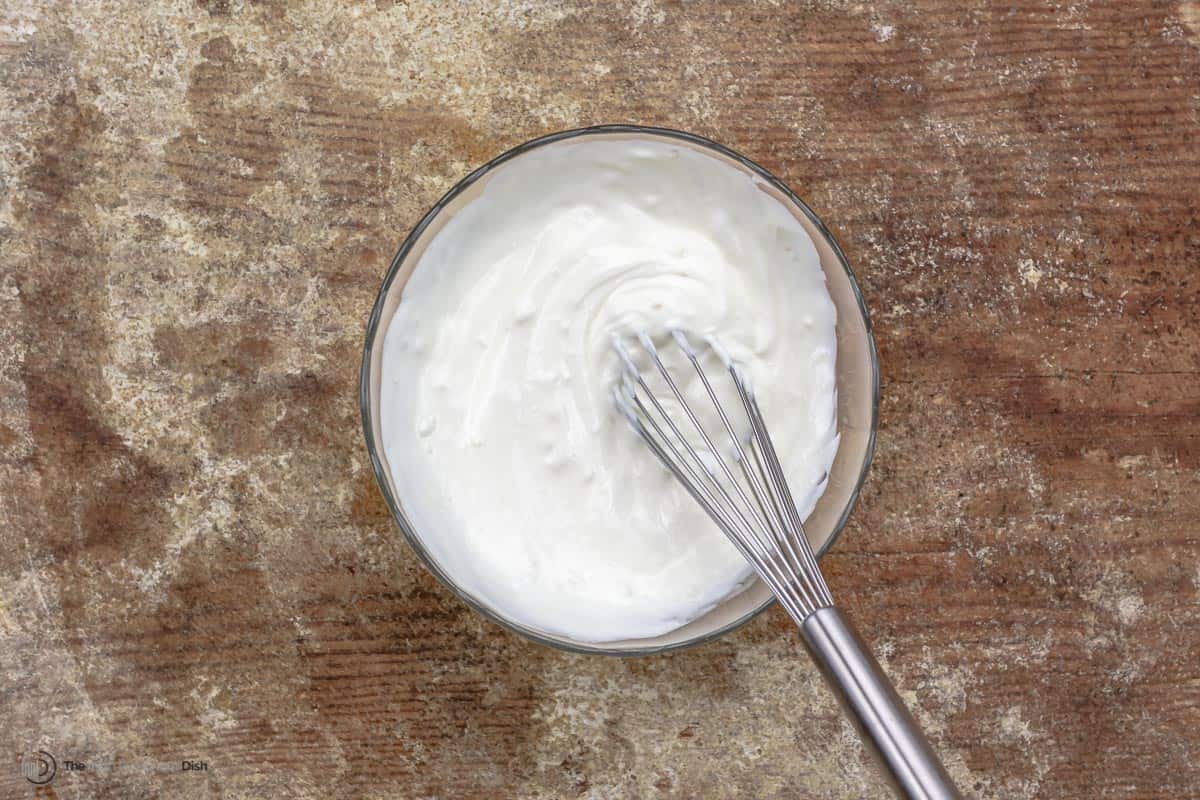 Garlicky yogurt sauce being whisked