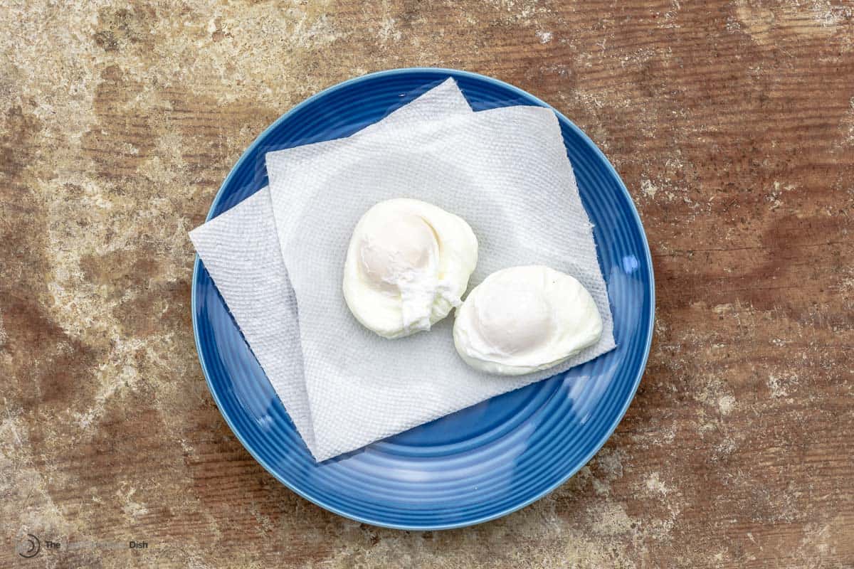 Two poached eggs on parchment paper