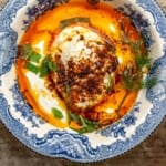 Overhead view of Cilbir poached eggs with garlic sauce