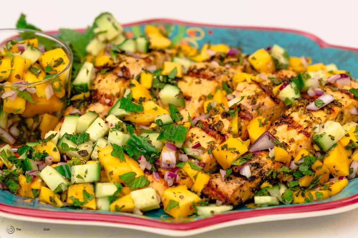 Grilled salmon with salmon salad served on a large plate