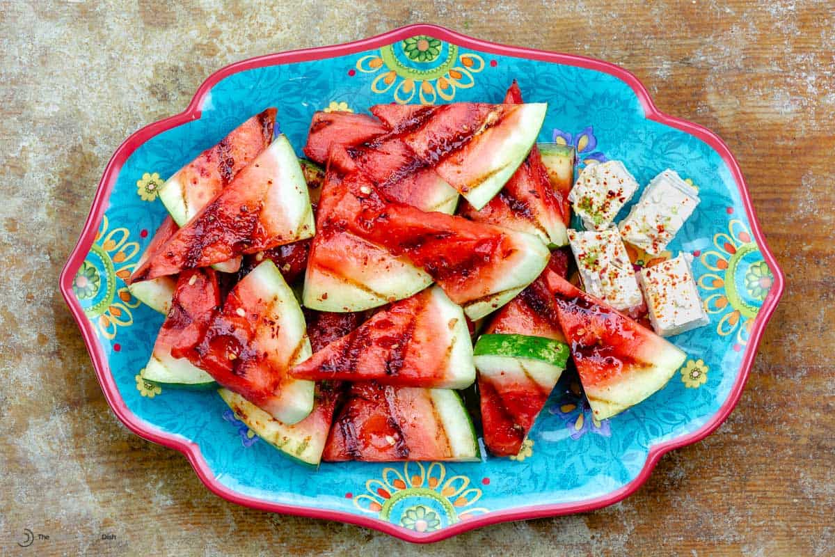 Grilled watermelon on a blue serving plate