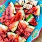 Grilled watermelon slices and feta on a blue plate