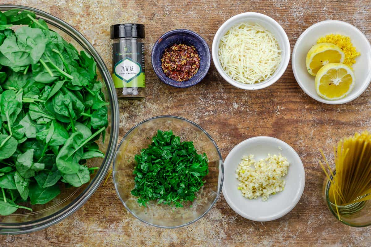 Overhead view of garlic spinach pasta ingredients