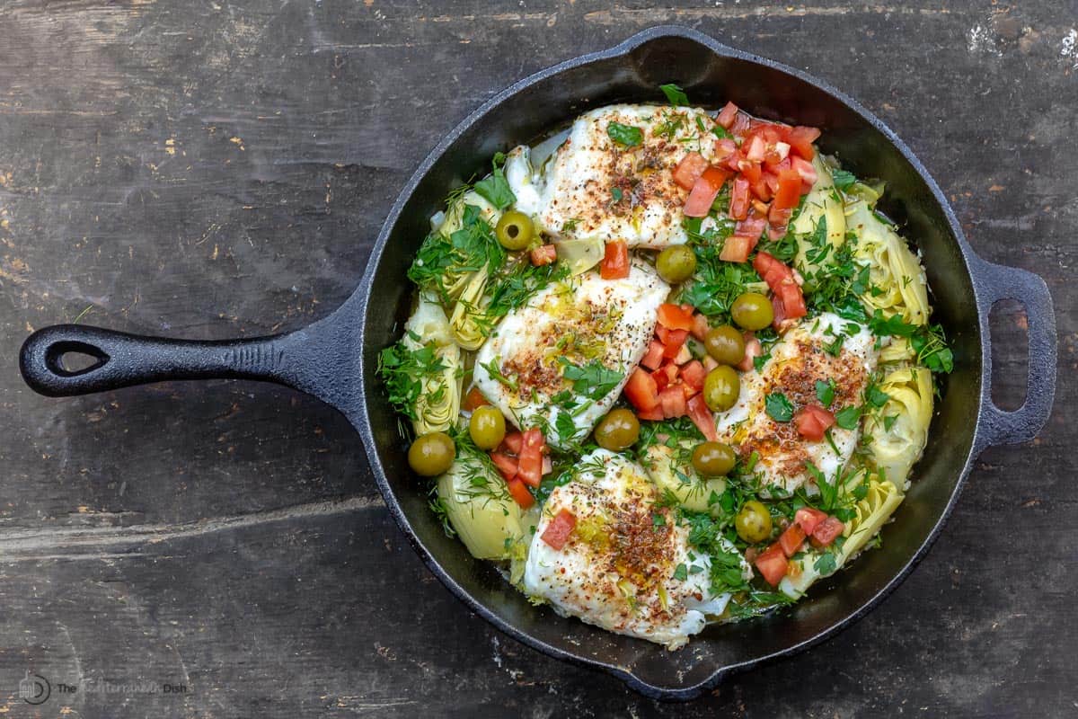 Lemon haddock with artichoke hearts in a skillet