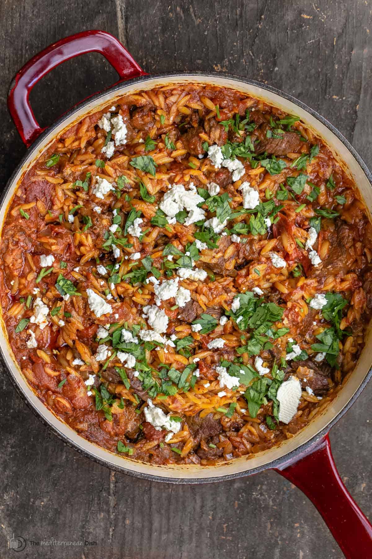 Youvetsi greek lamb stew topped with feta and parsley