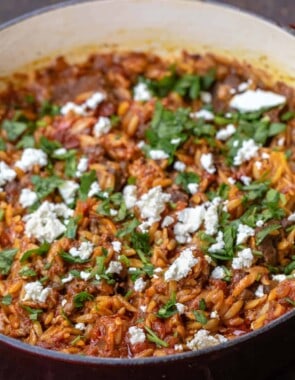 Close-up of Greek lamb stew garnished with feta and parsley