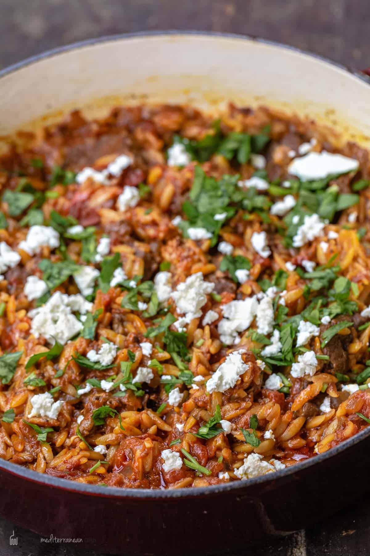 Close-up of Greek lamb stew garnished with feta and parsley