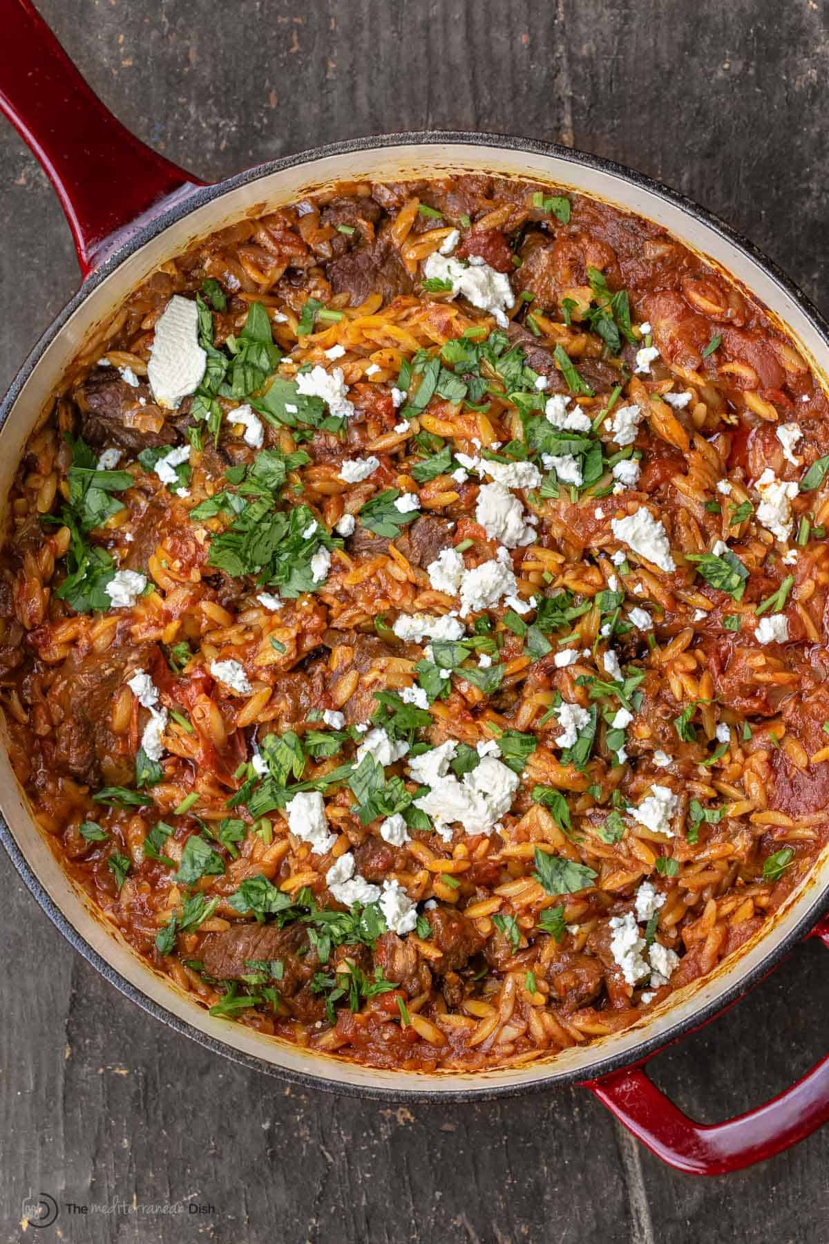 Overhead view of Greek lamb stew garnished with feta and parsley