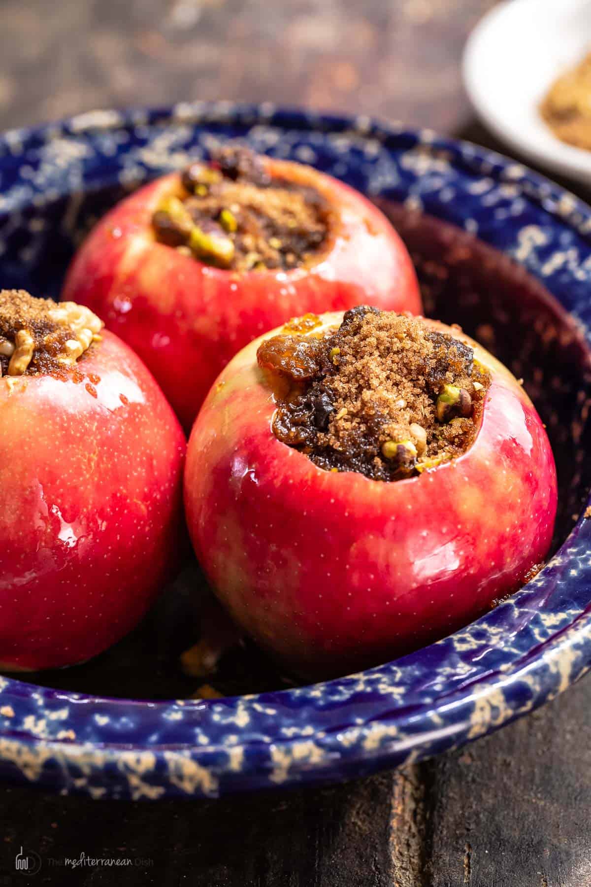 Side look at stuffed apples with cinnamon, brown sugar and nuts