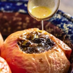 Brown sugar sauce being drizzled over baked apples