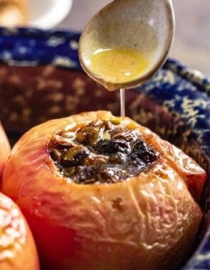 Brown sugar sauce being drizzled over baked apples