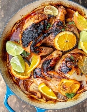 Roasted chicken with rosemary and citrus slices in a braiser