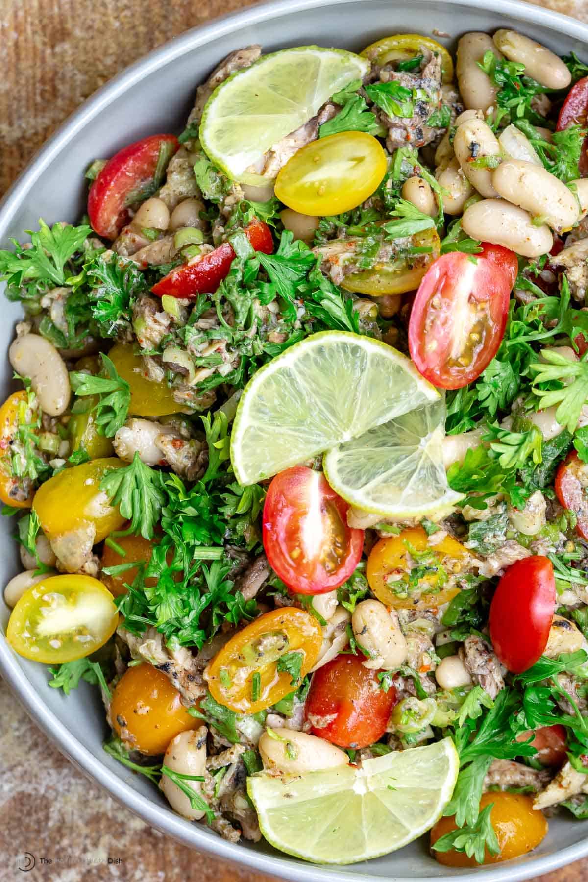 Overhead view of white bean and sardine salad in a white bowl