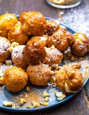 Loukoumades topped with honey syrup and crushed nuts