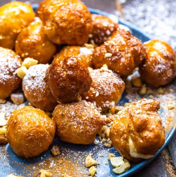 Loukoumades topped with honey syrup and crushed nuts