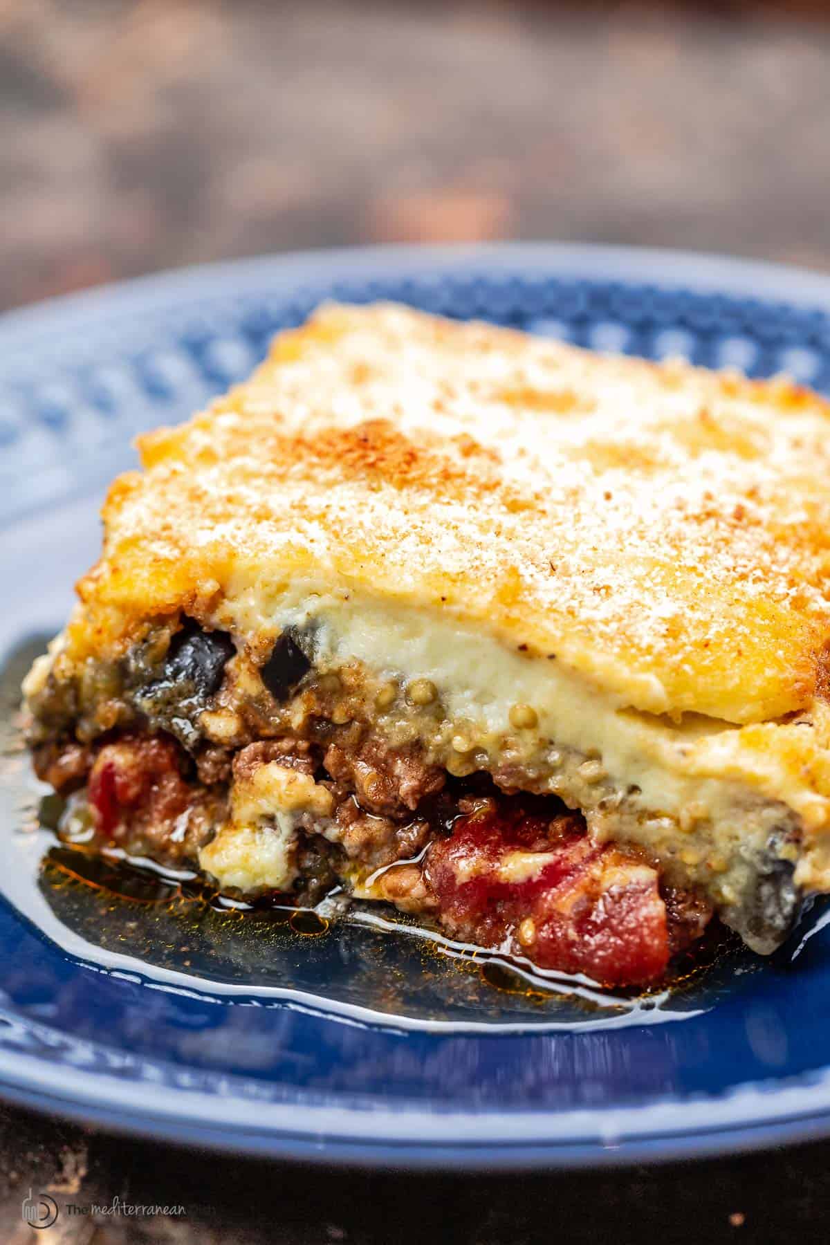 One slice of moussaka with meat sauce and bechamel topping