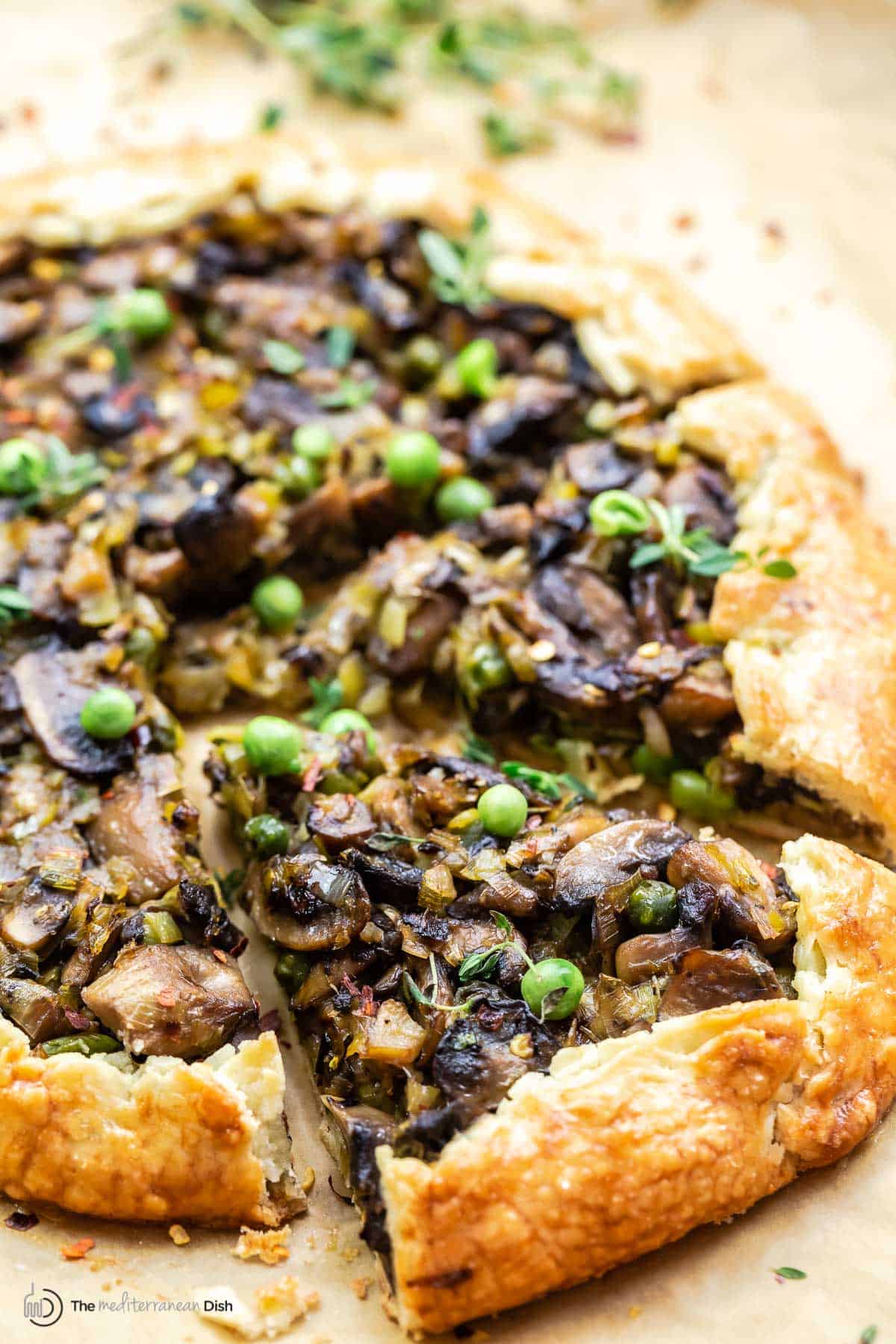 Mushroom-leek galette with a slice cut