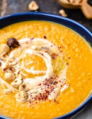 Overhead view of butternut squash soup topped with tahini and honey