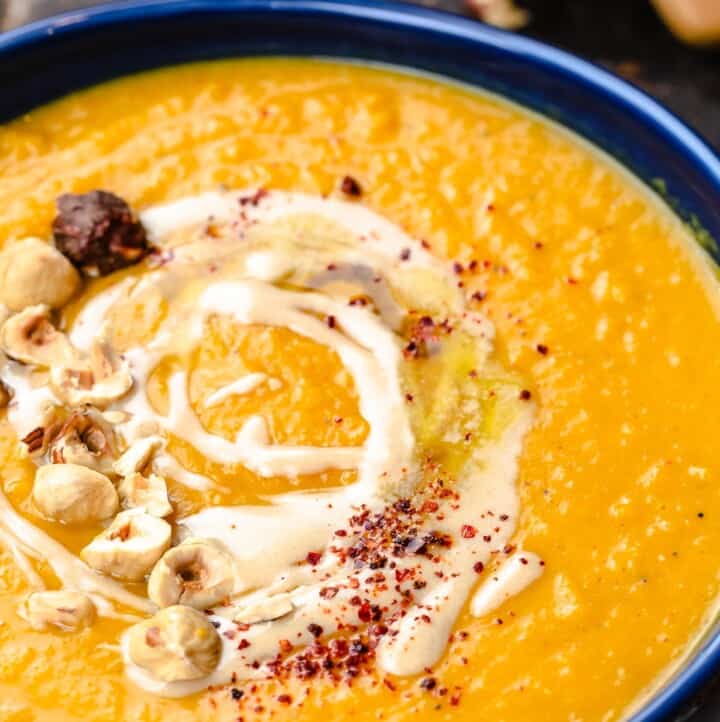 Overhead view of butternut squash soup topped with tahini and honey