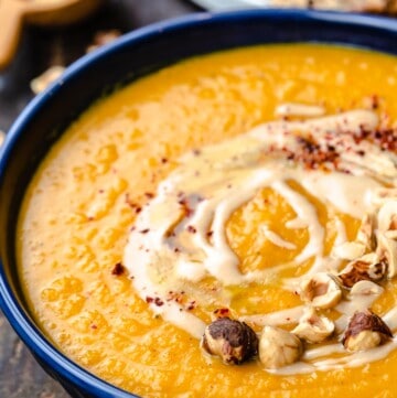 A bowl of roasted butternut squash soup with honey and tahini