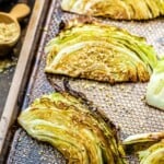 Charred cabbage wedges on a baking sheet