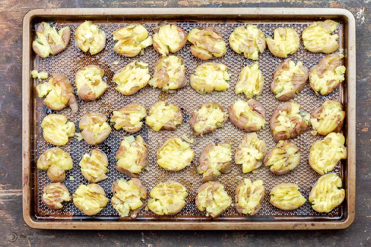 Smashed baby potatoes on a baking sheet ready to be baked