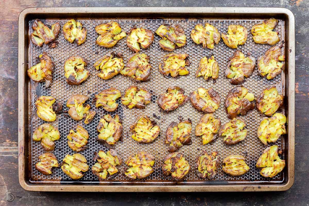 Baked smashed potatoes on a baking sheet