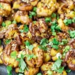 Close up of smashed potatoes with garlic and za'atar