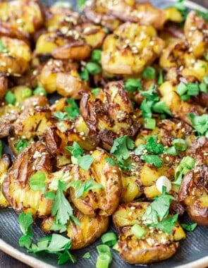 Close up of smashed potatoes with garlic and za'atar