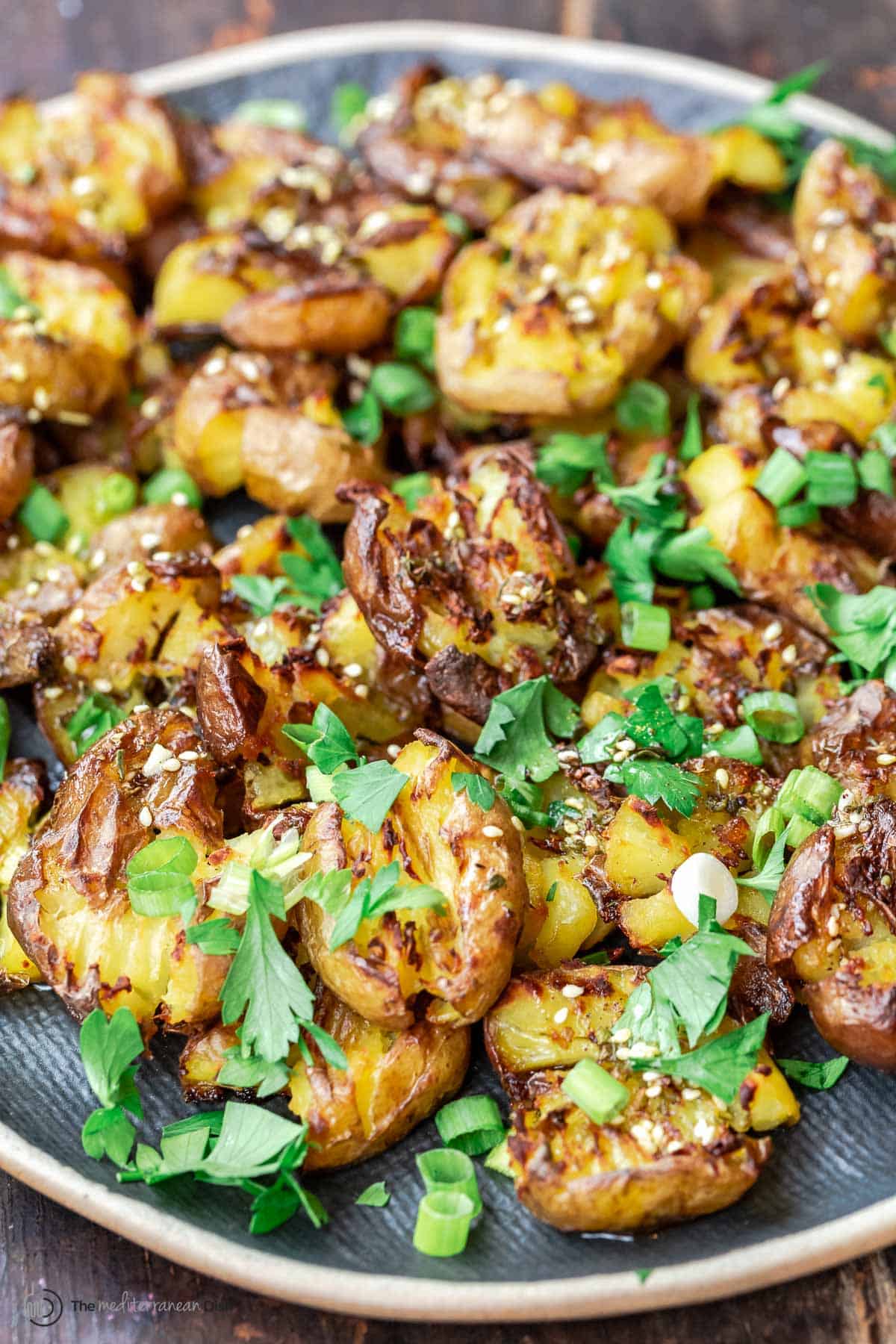 Close up of smashed potatoes with garlic and za'atar