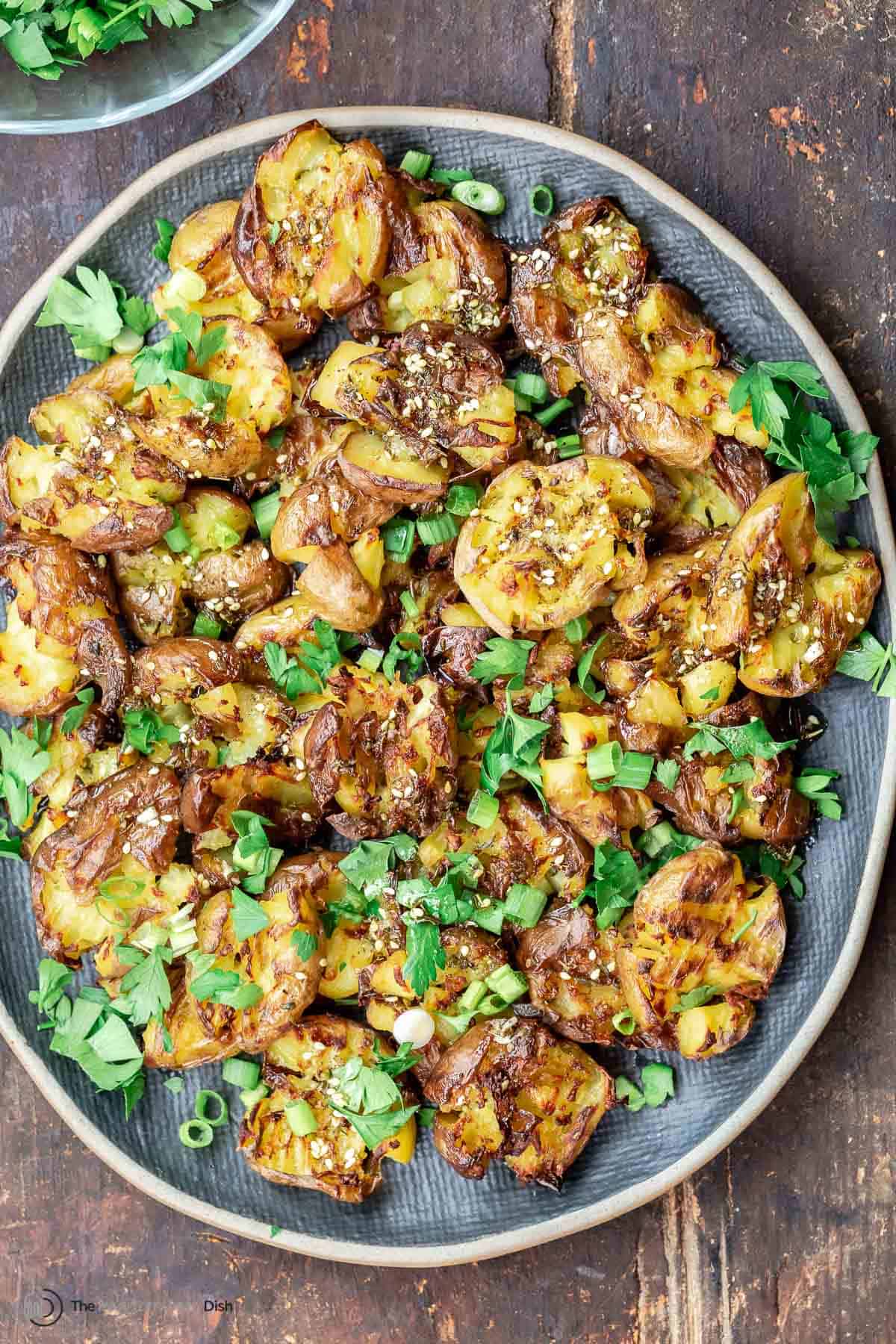 Smashed potatoes with garlic and za'atar on a plate