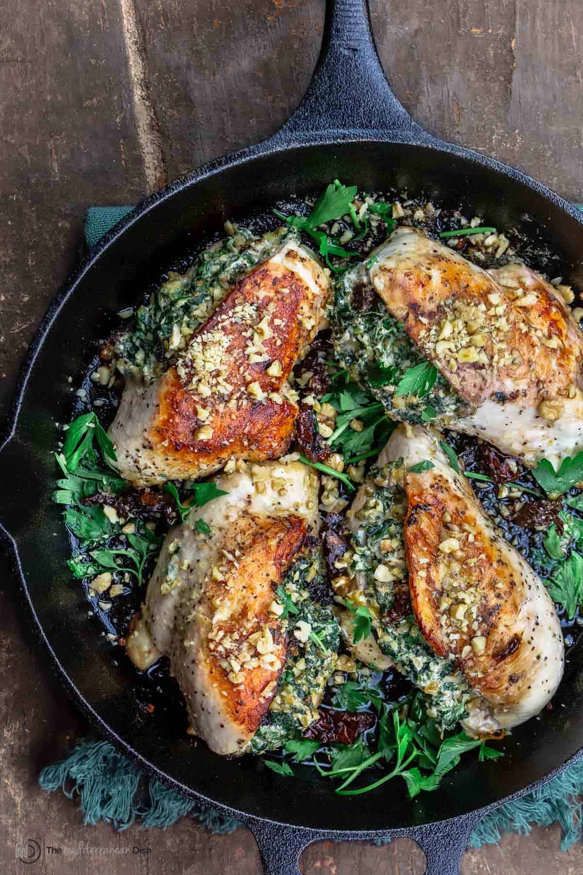 stuffed chicken breasts with spinach in a cast iron skillet