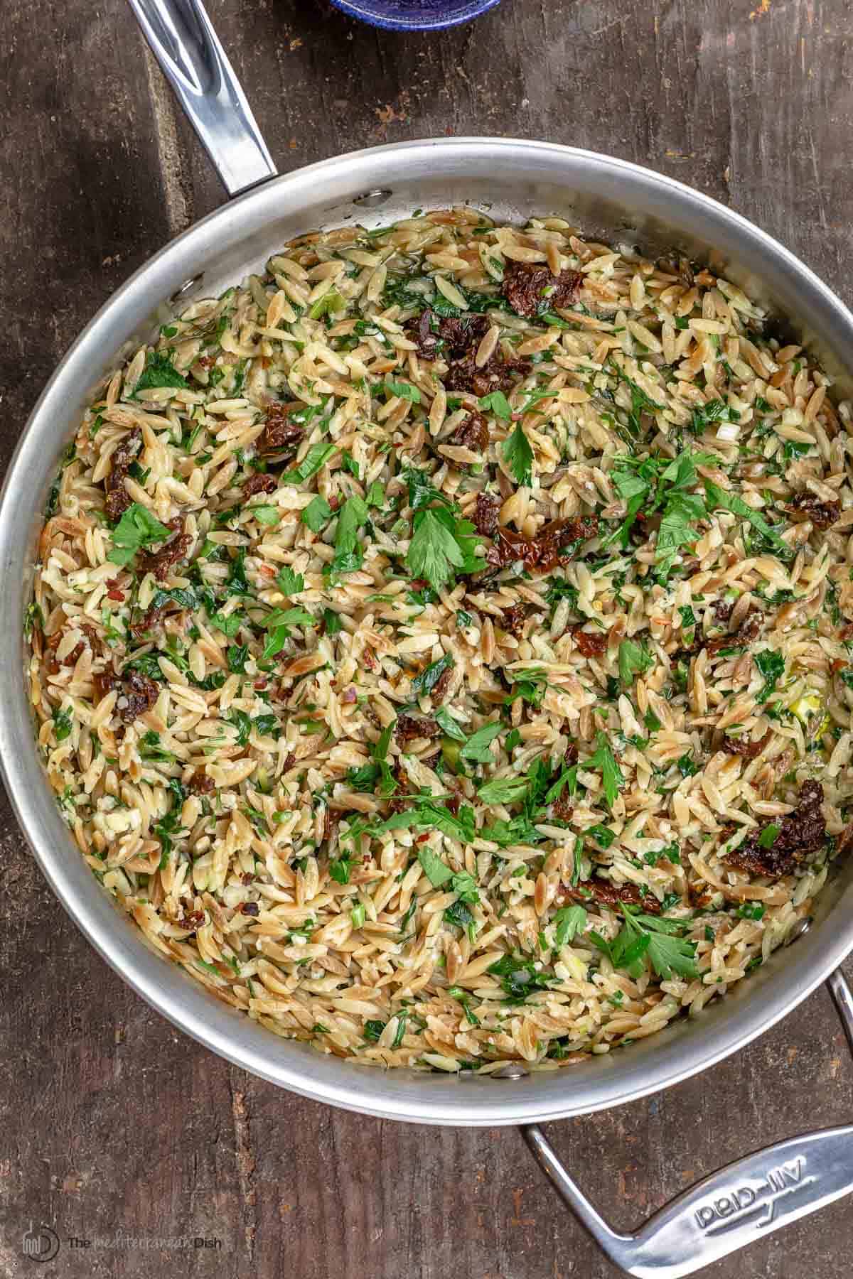 toasted orzo pasta with sundried tomatoes, parmesan, garlic and fresh herbs in one pan
